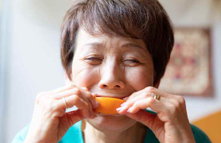 Senior Woman Eating Citrus Fruit