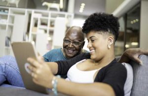 Senior And Granddaughter Doing Virtual Tour