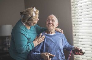 man in wheelchair with assistant