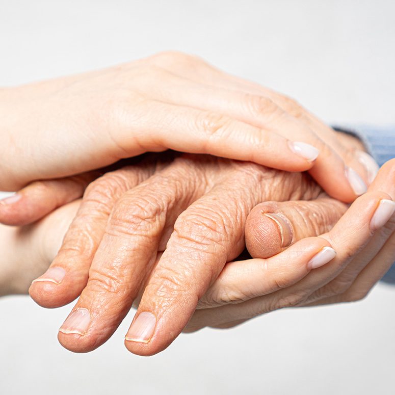 Young hands hold old hands. Support for the elderly concept.